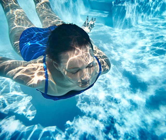 young woman swimming in pool