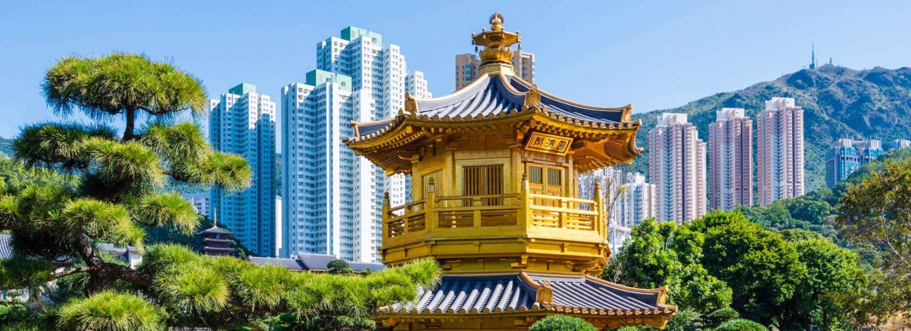 China, Hong Kong, Kowloon, The temple in the Nan Lian Garden Park with the surrounding skyscrapers